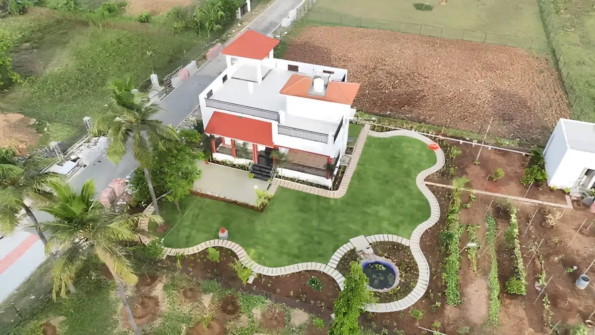 Elegant farmhouse landscape featuring curved pathways, manicured lawns, ornamental gardens, and eco-friendly outdoor living.